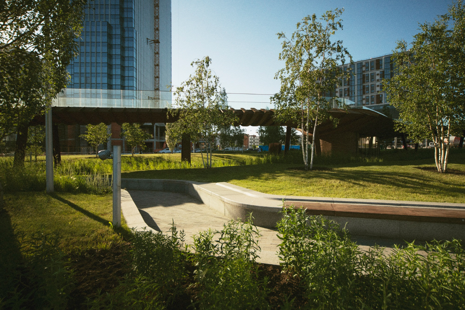Parc urbain contemporain avec passerelle et banc paysagé par jardins-paysages en Ariège